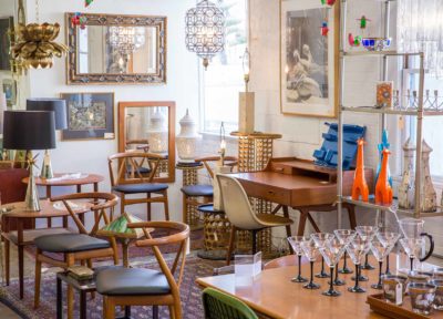 a room full of vintage furniture, lamps and paints at The Blue Door